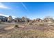 Street view of a residential area with houses, trees, and landscaped medians at 15310 E 108Th Way, Commerce City, CO 80022