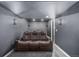 Home theater featuring tiered reclining seating, sconce lighting, and comfortable gray carpeting at 15310 E 108Th Way, Commerce City, CO 80022
