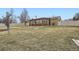 Well-manicured backyard with lawn, privacy fence, and sunroom with large windows at 4534 W 65Th Ave, Arvada, CO 80003