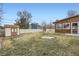 Spacious backyard featuring a well-maintained lawn, shed, and privacy fence at 4534 W 65Th Ave, Arvada, CO 80003