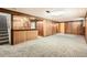Basement area with wood paneling, carpet, and a built-in bar with stairs at 4534 W 65Th Ave, Arvada, CO 80003