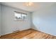 Cozy bedroom has hardwood floors, pale blue walls, a window, and classic lighting fixture at 4534 W 65Th Ave, Arvada, CO 80003