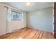 Comfortable bedroom has hardwood floors, neutral walls, and a window with curtains at 4534 W 65Th Ave, Arvada, CO 80003