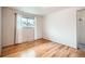 Bright bedroom features hardwood floors, a window with white curtains and neutral walls at 4534 W 65Th Ave, Arvada, CO 80003