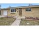 Charming brick home featuring a welcoming front door, bay window, and well-maintained landscaping at 4534 W 65Th Ave, Arvada, CO 80003