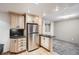 Kitchen featuring stainless steel refrigerator, granite countertops, and wood flooring at 4534 W 65Th Ave, Arvada, CO 80003
