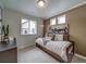This cozy bedroom features earth-tone walls, soft lighting, and comfortable decor at 13161 E 103Rd Pl, Commerce City, CO 80022