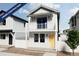 Charming two-story home with a balcony, a white picket fence and a welcoming yellow door at 13161 E 103Rd Pl, Commerce City, CO 80022