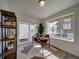 Well-lit home office features a modern desk, shelving, and a large window offering neighborhood views at 13161 E 103Rd Pl, Commerce City, CO 80022
