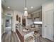 Modern kitchen with granite countertops, a stylish island, and contemporary pendant lighting at 13161 E 103Rd Pl, Commerce City, CO 80022