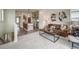 Open-concept living room and kitchen with breakfast bar, stylish decor, and modern finishes at 13161 E 103Rd Pl, Commerce City, CO 80022