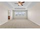 Spacious bedroom features a tray ceiling with fan, plush carpet, and bright windows at 22898 E Saratoga Pl, Aurora, CO 80015