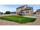Side view of the house and its backyard with a lawn and stone landscaping at 1864 Malibu Ct, Fort Lupton, CO 80621