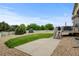 Large backyard with a lawn, stone features, fence, and access to the deck at 1864 Malibu Ct, Fort Lupton, CO 80621