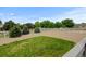 Well maintained backyard with a lawn, fence and privacy trees at 1864 Malibu Ct, Fort Lupton, CO 80621