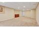 Finished basement with carpeting, drop ceiling, neutral paint and warm lighting at 1864 Malibu Ct, Fort Lupton, CO 80621