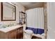 Bathroom with a vanity, mirror, toilet, and shower with a shower curtain at 1864 Malibu Ct, Fort Lupton, CO 80621