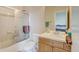 Bright bathroom featuring a shower and tub combo, with wooden cabinets and a white countertop at 1864 Malibu Ct, Fort Lupton, CO 80621