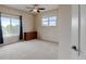 Spacious bedroom with two windows, neutral carpet, a ceiling fan, and a wood dresser at 1864 Malibu Ct, Fort Lupton, CO 80621
