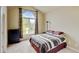 Well-lit bedroom features large windows, neutral walls, and comfortable carpet at 1864 Malibu Ct, Fort Lupton, CO 80621
