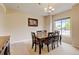 Formal dining room with a chandelier, table for six, and large window offering a pleasant view at 1864 Malibu Ct, Fort Lupton, CO 80621