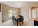 Inviting dining room featuring a chandelier, window, and room for six around a wooden table at 1864 Malibu Ct, Fort Lupton, CO 80621