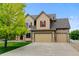 Two-story house boasting a manicured lawn, a three-car garage and mature landscaping at 1864 Malibu Ct, Fort Lupton, CO 80621
