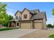 Charming two-story home featuring a three-car garage, stone accents, and well-manicured landscaping at 1864 Malibu Ct, Fort Lupton, CO 80621