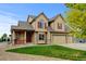 Charming two-story home featuring red shutters, stone accents, and a well-maintained front yard at 1864 Malibu Ct, Fort Lupton, CO 80621