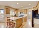 Bright kitchen with center island, stainless steel appliances, and light wood cabinets at 1864 Malibu Ct, Fort Lupton, CO 80621