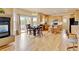 Eat-in kitchen featuring a fireplace, access to the deck and wooden cabinetry at 1864 Malibu Ct, Fort Lupton, CO 80621