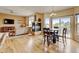 Open concept living room with a fireplace, hardwood floors, and sliding glass doors to the exterior at 1864 Malibu Ct, Fort Lupton, CO 80621