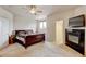 Bright main bedroom features a fireplace, ceiling fan, and ensuite bathroom and walk-in closet at 1864 Malibu Ct, Fort Lupton, CO 80621