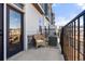 Private outdoor balcony includes a chair and view of the neighborhood with wrought iron railing at 1071 Oak Cir, Lakewood, CO 80215