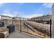 View from private balcony, featuring comfortable chair and neighborhood views beyond wrought iron railing at 1071 Oak Cir, Lakewood, CO 80215