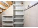 Basement area featuring built-in shelving and coat hooks, offering extra storage space at 1071 Oak Cir, Lakewood, CO 80215