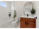Bright bathroom features modern vanity, framed mirror and a tub and shower combination at 1071 Oak Cir, Lakewood, CO 80215