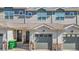 Charming townhouse showcasing a well-maintained facade with a garage and inviting entrance, blending comfort and curb appeal at 1071 Oak Cir, Lakewood, CO 80215