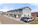 Well maintained townhome exterior with neutral colors and attached garages, showing multiple parked cars at 1071 Oak Cir, Lakewood, CO 80215