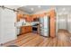 Modern kitchen featuring stainless steel appliances, wood cabinets, and sleek finishes for a comfortable cooking experience at 1071 Oak Cir, Lakewood, CO 80215