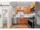 Updated kitchen with stainless steel appliances, wooden cabinetry, and contrasting countertops at 1071 Oak Cir, Lakewood, CO 80215