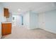 Spacious basement with carpeted flooring, bar area and door to an unfinished space at 5721 S Jellison St, Littleton, CO 80123