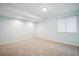 Carpeted basement features recessed lighting, a window, and light blue painted walls at 5721 S Jellison St, Littleton, CO 80123