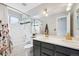 Bathroom featuring double sinks, modern fixtures, tub, and shower at 5721 S Jellison St, Littleton, CO 80123