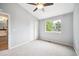 Bright bedroom features vaulted ceiling, ceiling fan, carpet, and a window with a view of the outdoors at 5721 S Jellison St, Littleton, CO 80123