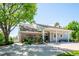 Community clubhouse with covered entry, brick facade, professional landscaping, and convenient parking at 5721 S Jellison St, Littleton, CO 80123