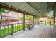 Covered deck with gray wood flooring, bench seating, and string lights at 5721 S Jellison St, Littleton, CO 80123