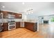 A stylish kitchen with stainless appliances, granite countertops, and seamless flow to living area at 5721 S Jellison St, Littleton, CO 80123