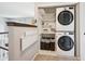 Conveniently located laundry area with stacked washer/dryer and folding table at 5721 S Jellison St, Littleton, CO 80123