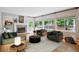 Bright living room features a cozy fireplace, large windows, and stylish decor for comfortable living at 5721 S Jellison St, Littleton, CO 80123